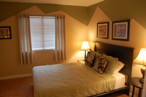 A bedroom with a bed, two bedside lamps, a window with curtains, and two framed pictures on the wall. - Families! Get-a ways! Private Home! - Pool! Billiard Table! Couples! Golfers! (Henderson)