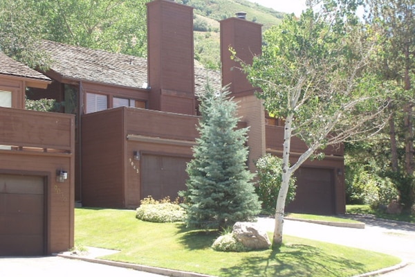 Front of units showing 2-car garage and driveway parking.