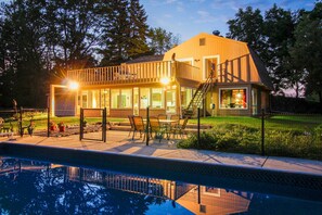 A house with a pool, a deck, and a staircase leading to a balcony. - 7  Acre Estate,  Great Farm House with Pool, Hot tub, Fishing Pond, World Series (Caledonia)