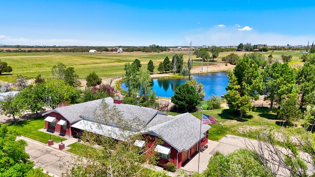 A red barn with a flag, a pond, and a clear sky. - LUXE Lodge 80ac. Huge pond cattle Ranch Views Close Nat Parks Ski McPhee (Dolores)