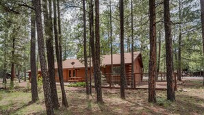 A log cabin surrounded by tall pine trees in a forested area. - COZY CABIN IN COUNTRY CLUB WITH FOREST VIEWS-PETS WELCOME! (Pinetop)