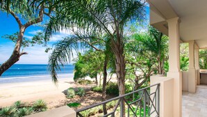 A balcony with a view of a beach and ocean.