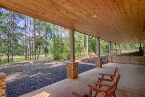 Relax in a serene outdoor space surrounded by nature, featuring benches and a fire pit.