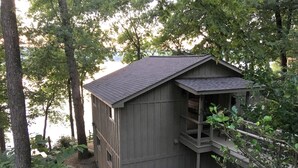 A small wooden cabin with a sloped roof, a porch, and a window. - Secluded getaway on Lake Catherine, minutes from town - birds, fishing, & kayaks (Hot Springs)