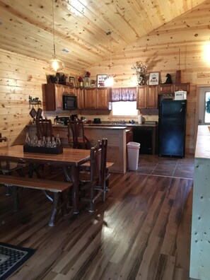 Enjoy meals at the wooden dining table surrounded by comfortable chairs.