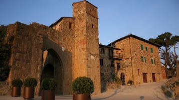 Experience the charm of a historic, fortified structure with a prominent arched entrance and tower.