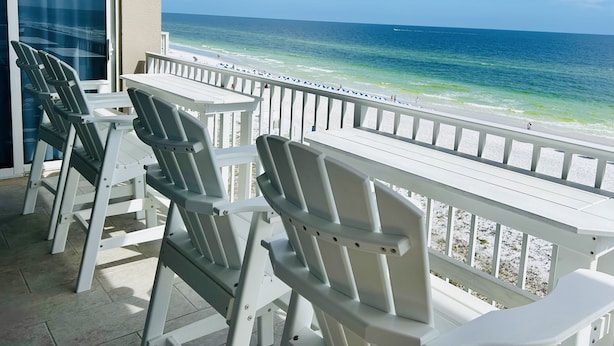 A balcony with white chairs and a view of the beach. - IP 616-Completely Renovated, Luxury Ocean Front 3bdrm/3bath (Fort Walton Beach)