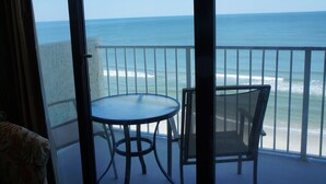 A balcony with a table and chairs overlooking the ocean. - End Unit:  8th Floor Ocean Front (Myrtle Beach)