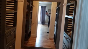 A hallway with wooden flooring, a large mirror, and dark wooden shelving units on either side. - Ocean Retreat -  Rustic style house  w/pool, Pet Friendly.  (Rehoboth Beach)