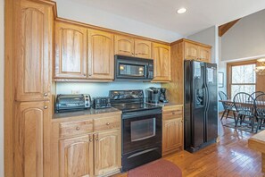 Dishwasher, coffee/tea maker, cookware/dishes/utensils, dining tables