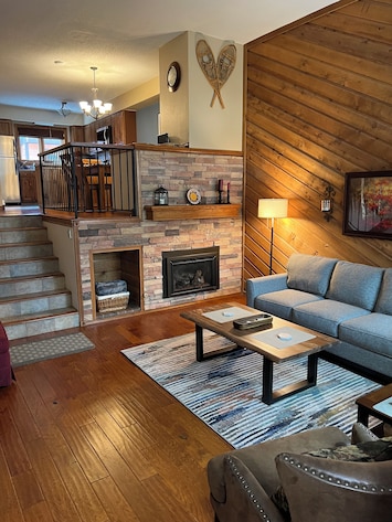 Living room with kitchen up the stairs