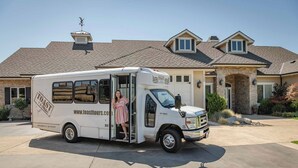 A white food truck parked in front of a house with a stone facade, a stone archway, and a clear sky. - Single Story Condo, All New w/BBQ at Blacklake w/3 Golf Courses (Nipomo)