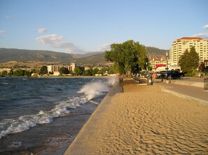 A coastal hotel with a beachfront view, a sandy promenade, and a mountain backdrop. - Squires House - Amazing views!   Minutes to beaches, trails & wineries! (Penticton)