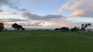 A golf course with a view of the ocean and a sunset. - Beautifully Furnished-Great for families 3 Bed, 2 1/2 Bath Nihilani, Princeville (Princeville)