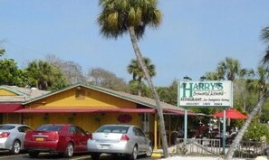 Een restaurant genaamd Harry's met terras en een rode luifel.