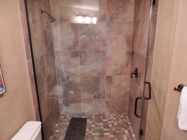 A glass-enclosed shower with a tiled floor, a towel rack, and a showerhead. - SKI-IN / SKI-OUT 5 BEDROOM, walking distance to everything in town! (Telluride)