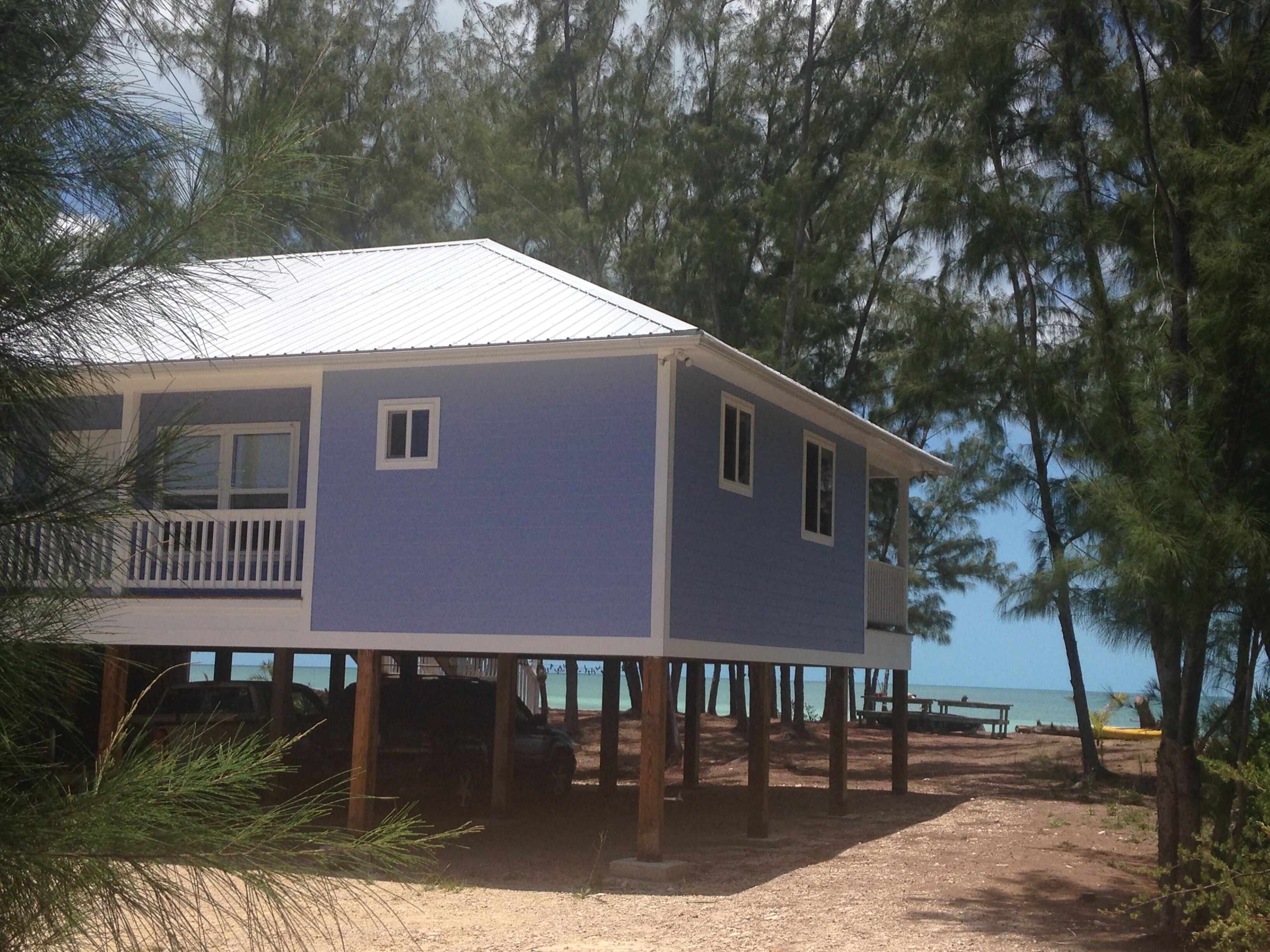 view of the house and beach beyond from the driveway
