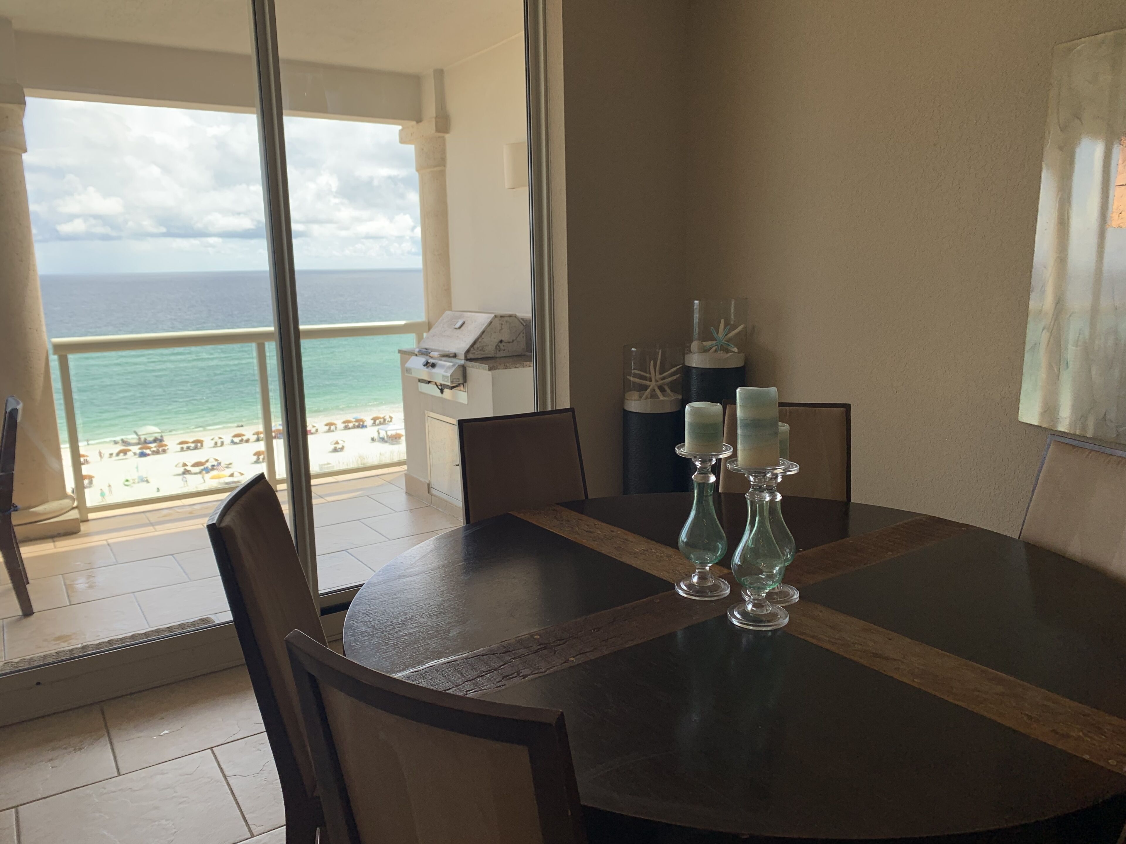 A dining area with a view of the beach and ocean.