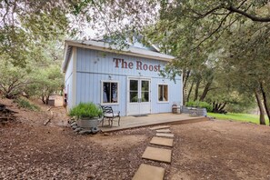 A rustic building named "The Roost" with a wooden deck, potted plants, and outdoor seating. - Julian Farmhouse/Fenced 2 acres with spa, right outside Julian. Pet Friendly! (Julian)