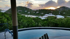 A pool with a view of a hillside with houses and a sunset. - Samba Azul 2 br2 ba ensuites w ACs private pool beautiful sunsets &new GENERATOR (St.John)