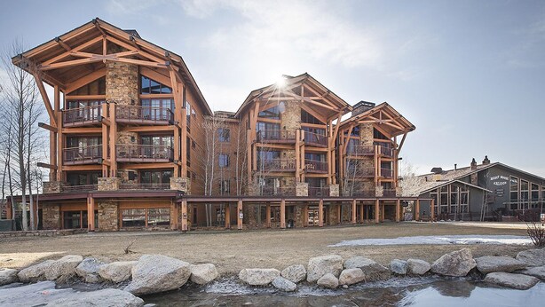 A large, multi-story lodge with balconies and a stone facade. - Teton Village Ski-In Ski-Out Crystal Springs Luxury Condominium Jackson Hole WY (Teton Village)