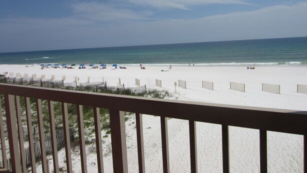 A beach view from a balcony with a wooden railing. - Third Floor Private Beach Terrace (Fort Walton Beach)