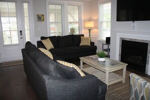 Relax in comfort with a sofa, coffee table, and fireplace.