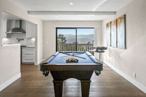 A pool table in a room with a view of mountains through a large window. - Valley Views: Newly Remodeled 4br 4ba with Spectacular Valley Views (Carmel)