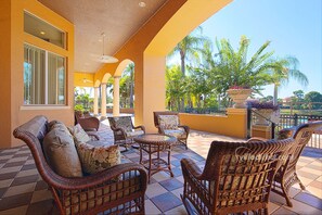 Relax in comfort on the spacious patio, surrounded by lush greenery and a serene landscape.