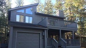 A two-story house with a garage, a balcony, and a staircase leading to the upper level.