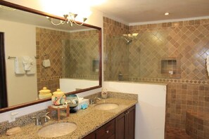 A bathroom with two sinks, a large mirror, and a shower. - one block to medano beach , 2 blocks to the Cabo Marina & Downtown Cabo (Cabo San Lucas)