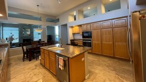 A spacious kitchen with granite countertops, wooden cabinets, and stainless steel appliances. - Desert Retreat - 4BR/3BA Heated Pool & Spa - Recently Renovated - Monthly Rental (Scottsdale)