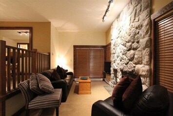 Seating area with stone fireplace and flat screen TV