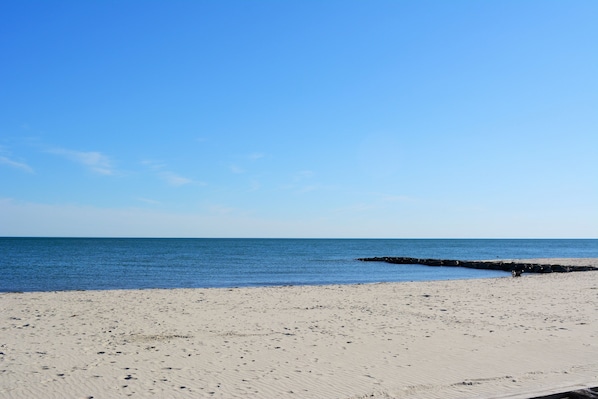 A beach with a clear sky and calm sea.