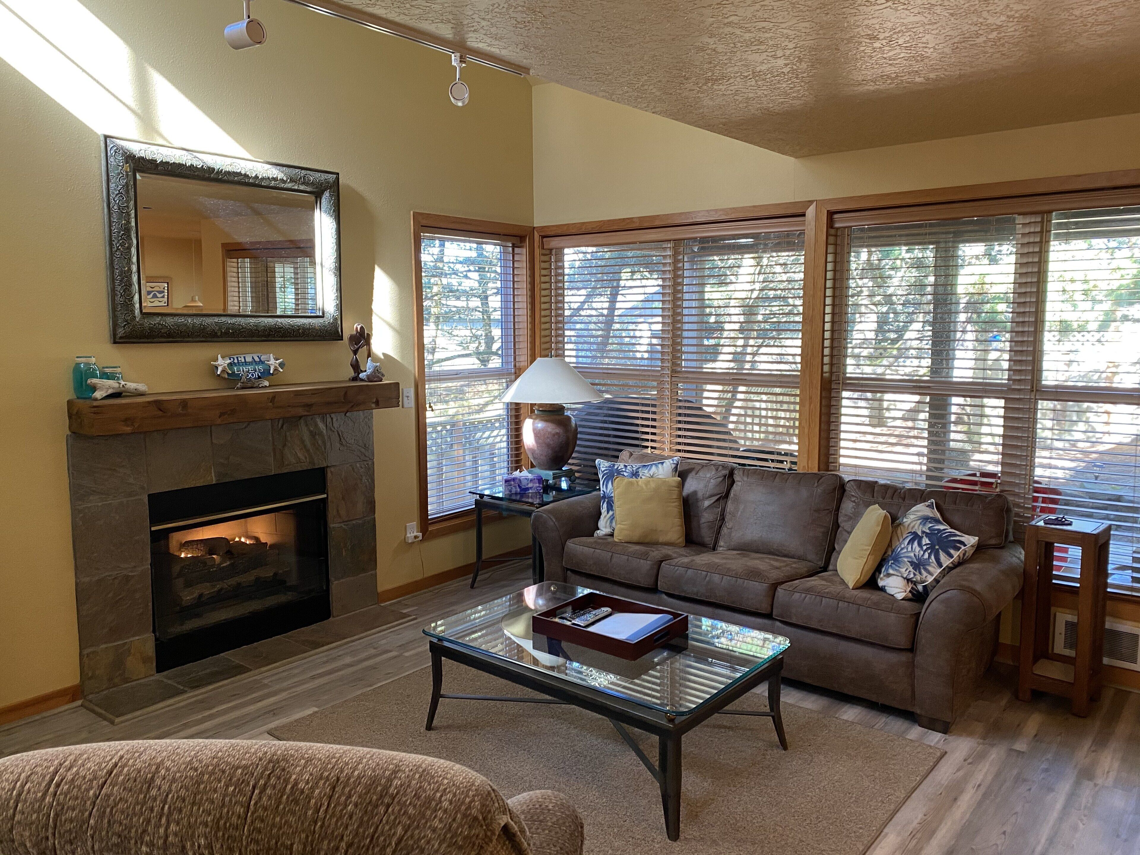Cozy living room with gas fireplace and large screen TV. 