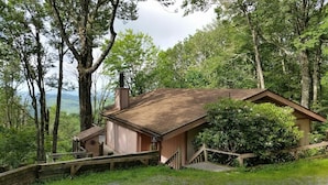 A rustic cabin with a wooden exterior, a chimney, and a small porch. - Million-Dollar Views, spectacular! Sugar Mountain Cabin 3 Bedrms 3 bath sleeps 7 (Sugar Mountain)