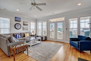 Relax in this stylish living room with a large sofa, coffee table, and armchair.