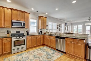 Enjoy cooking in this well-equipped kitchen with a large island, microwave, oven, and dishwasher.