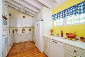 Enjoy cooking in this well-equipped kitchen with a refrigerator, microwave, and dishwasher.