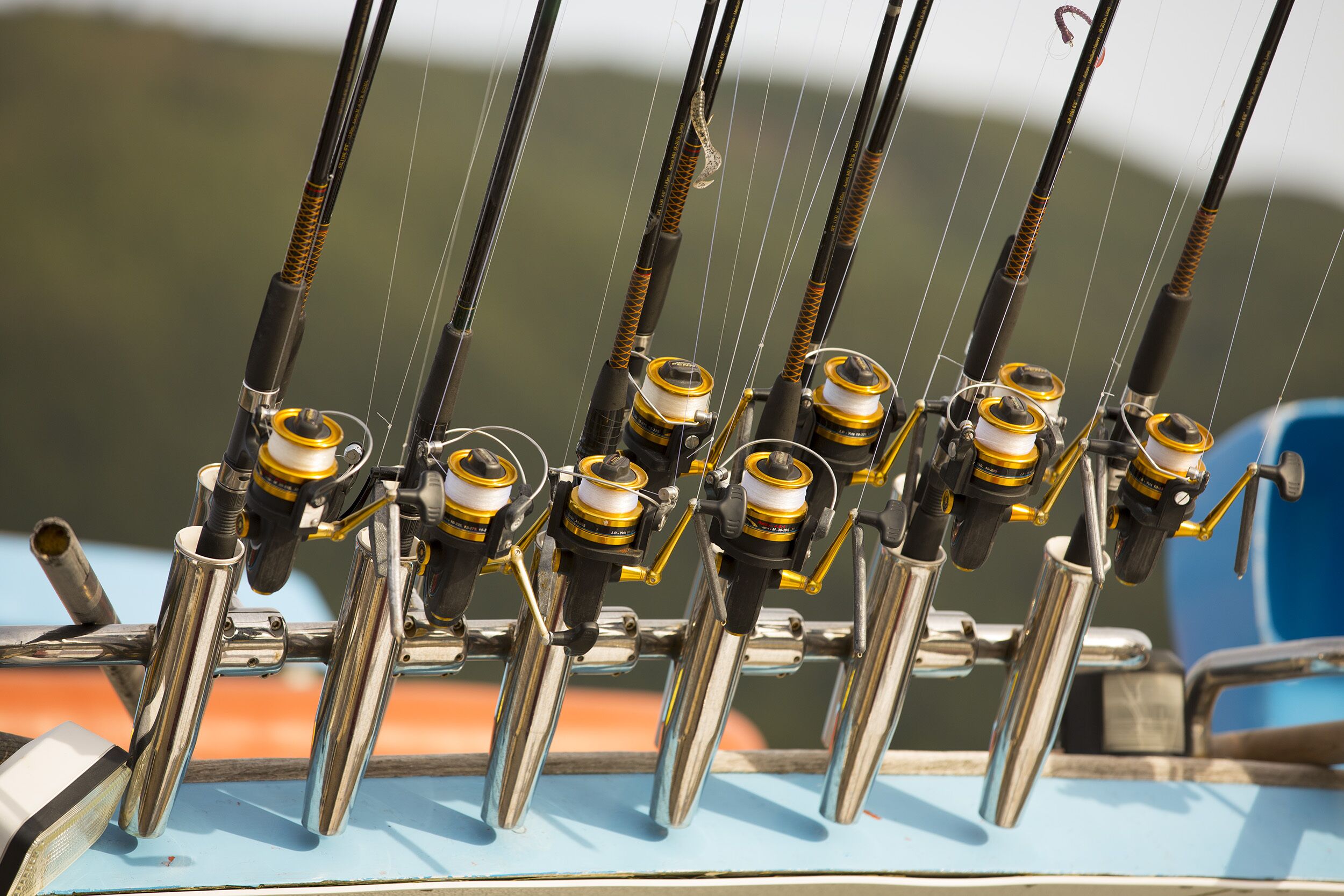 A fishing rod rack with multiple fishing rods.