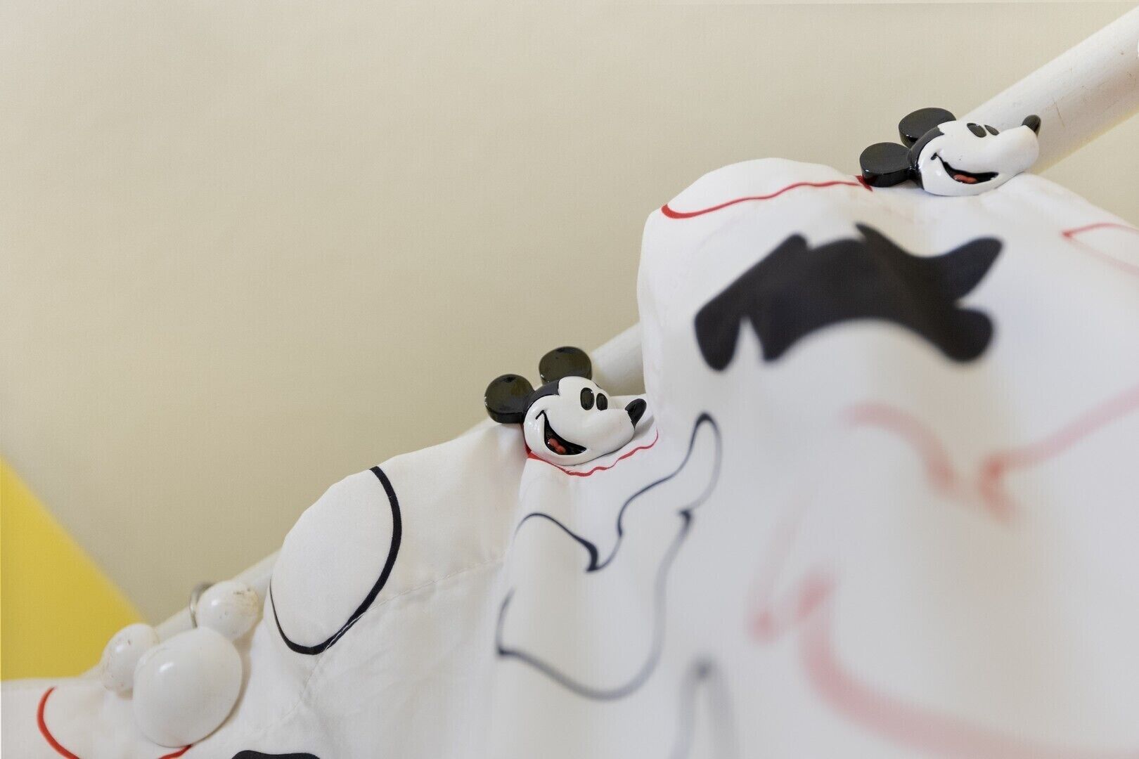 A white object with cartoon character designs and red accents.