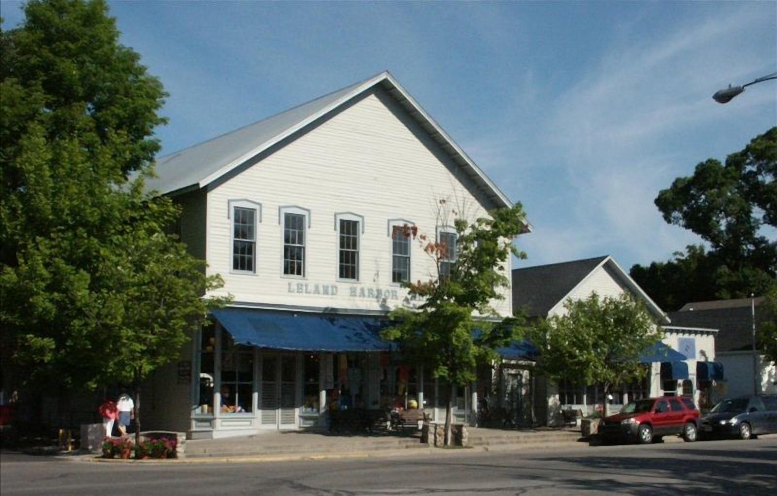 A two-story building with a sign reading "Leland Harbor House 2004".