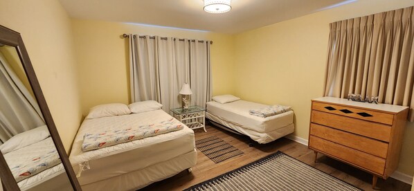A bedroom with two beds, a nightstand, a dresser, and a mirror. - BEST VALUE!! SPACIOUS Home! Short Walk to Beach! Many Amenities!! Great Reviews! (Rehoboth Beach)
