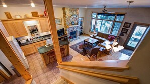 A spacious living area with a fireplace, a dining area, and a kitchen.