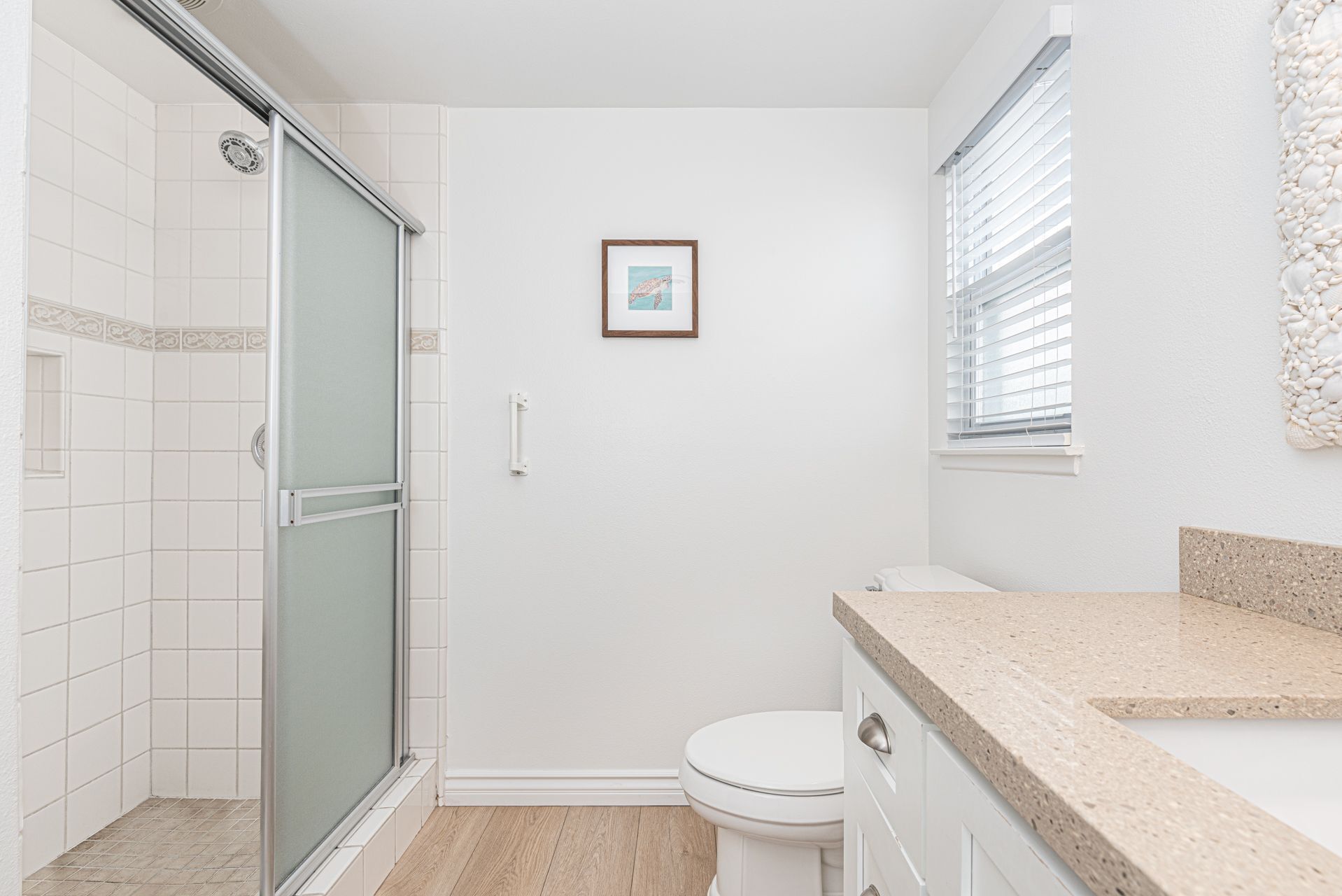 A bathroom with a shower, toilet, and sink.
