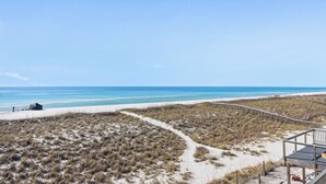 A beach with a wooden boardwalk, sandy dunes, and a clear blue sky. - Touch of Paradise-Gulf Front Home Newly Renovated. Pup Friendly. Sleeps 12 (Navarre)
