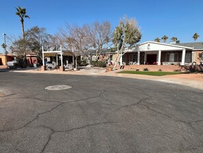 A street with a building featuring a covered patio and a brick facade. - Downtown Phoenix attached 2 king bed rooms 1 bath suite  (Phoenix)