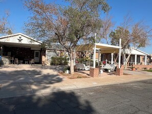 A two-story building with a covered patio area, outdoor seating, and a brick facade. - Downtown Phoenix attached 2 king bed rooms 1 bath suite  (Phoenix)