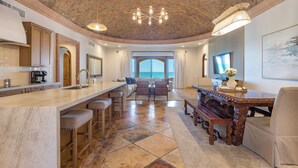A spacious kitchen with a bar area, a dining table, and a view to the outside. - Villa #18:  LUXURY 5 Bed/5 bath Oceanfront home for 14 guests.  Renovated 3/26. (Puerto Peñasco)