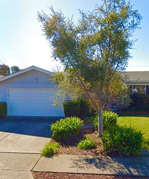 Stroll through the beautifully manicured lawn to this single-story home.